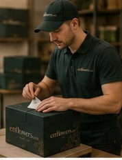An enflowers florist packing a gift box